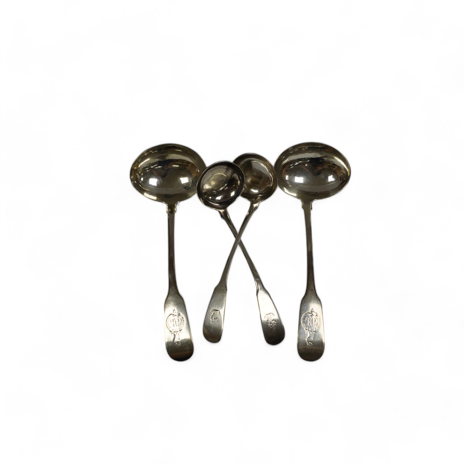 A pair of George IV Scottish silver fiddle pattern sauce ladles, Andrew Wilkie, Edinburgh, 1824, 15.2cm, together with a similar Irish pair by Richard Garde and another maker's mark RT, Dublin, 1823, 4.7oz. Condition - f